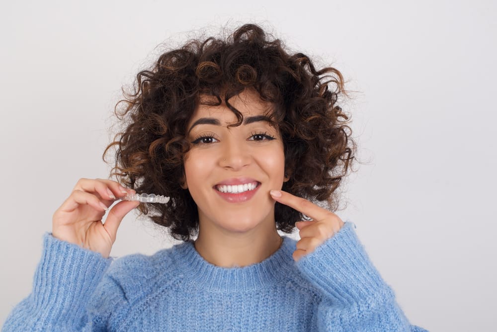woman holding an invisalign - Invisalign in Bellevue